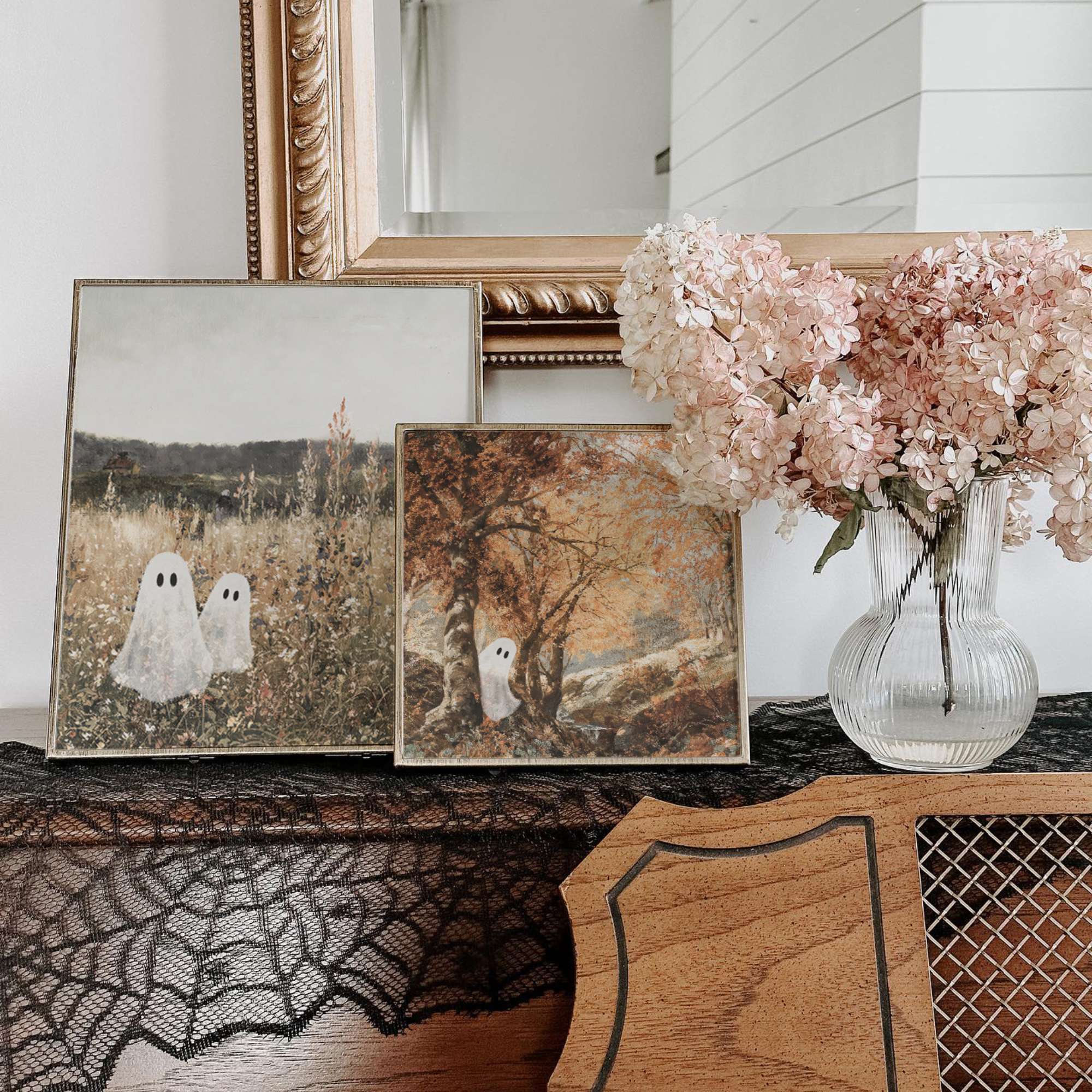 Interior photo of prints with cute ghosts in vintage landscape